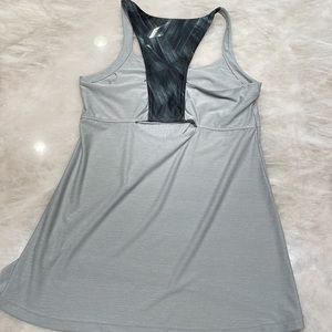 Silver/grey athleisure sports tank with open back cut out. Built in sports bra.